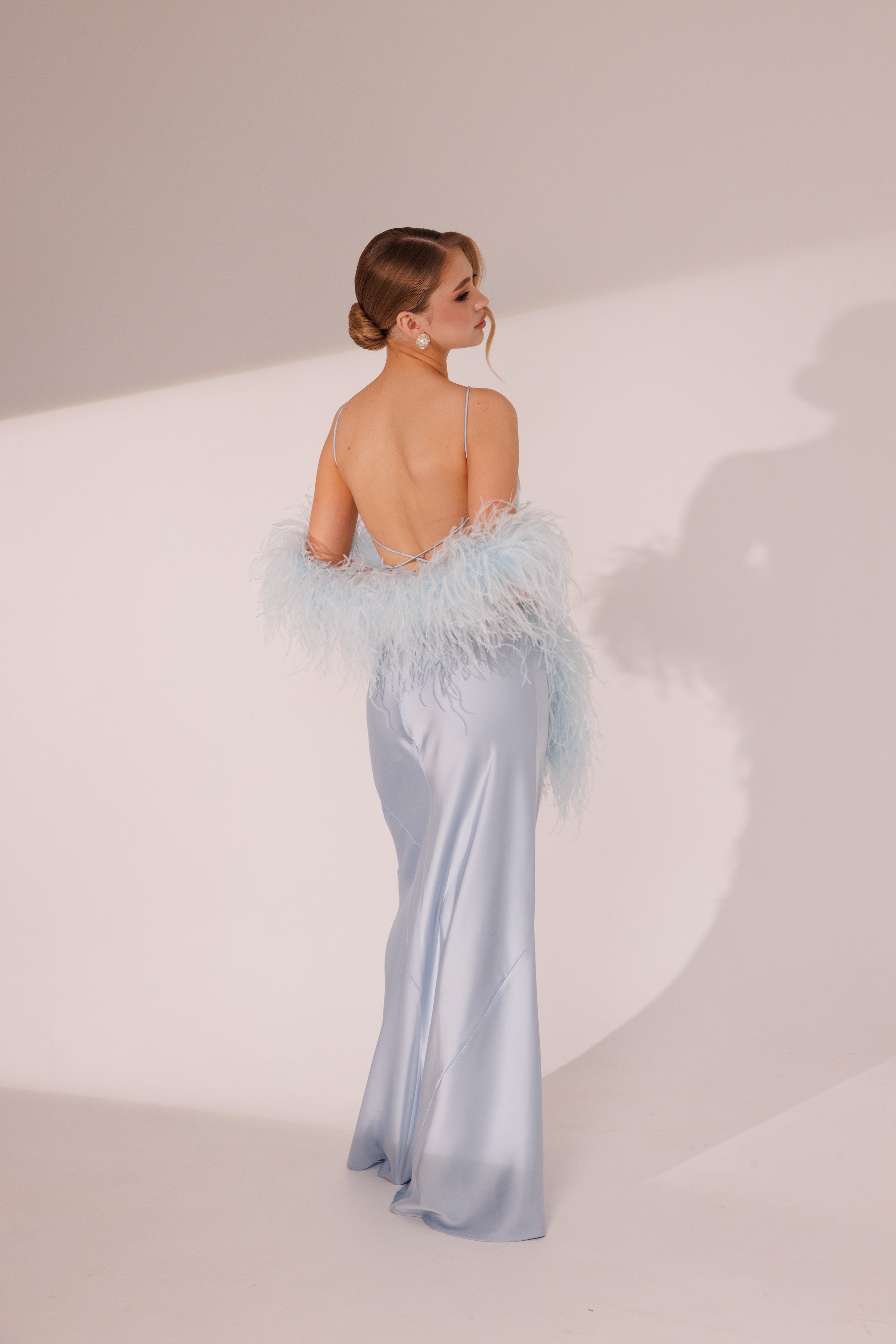 Elara Dress in blue color styled with matching feather boa