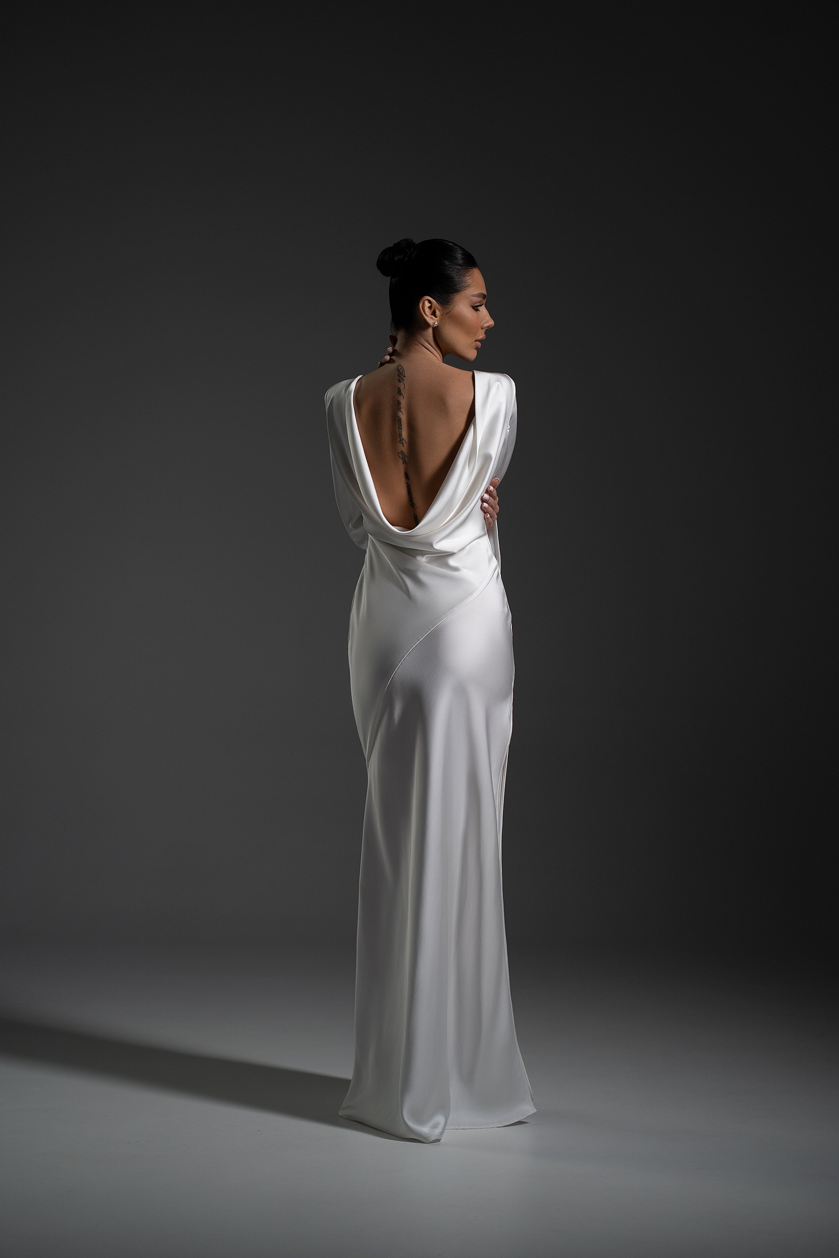 Side view of Naomi Dress with long sleeves and flowing maxi skirt