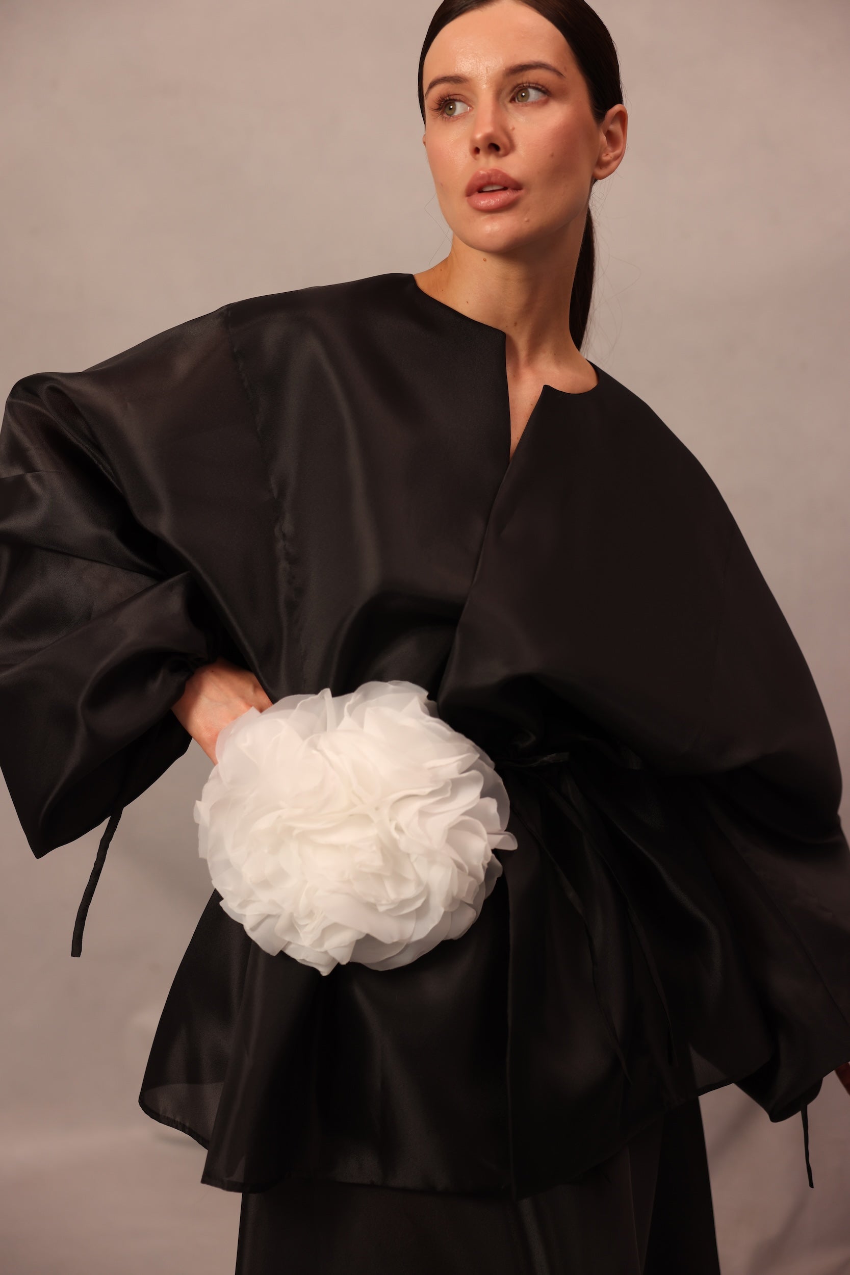 Close-up of Set Comte black wrap top with voluminous sleeves