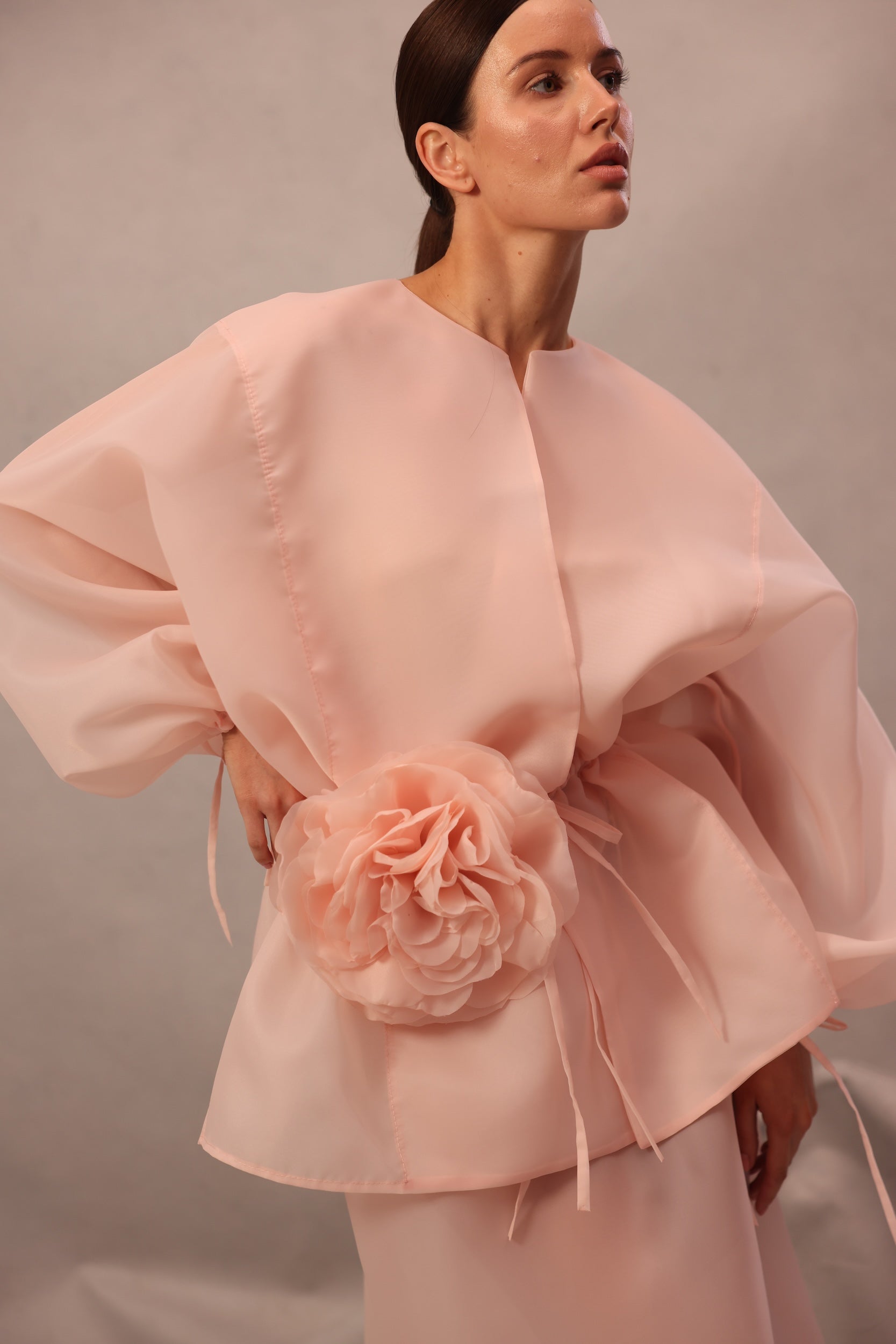 Close-up of Set Comte in pink-peach color with flower waist detail