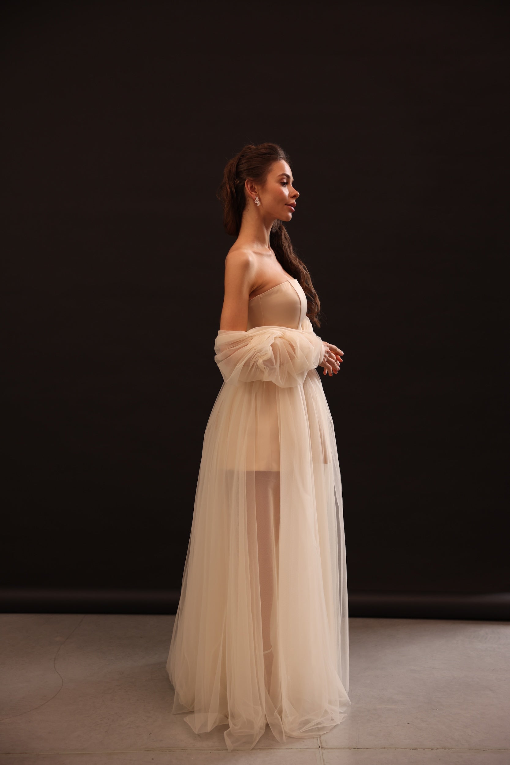 Side view of Voile Sateen Dress in beige color with flowing tulle skirt