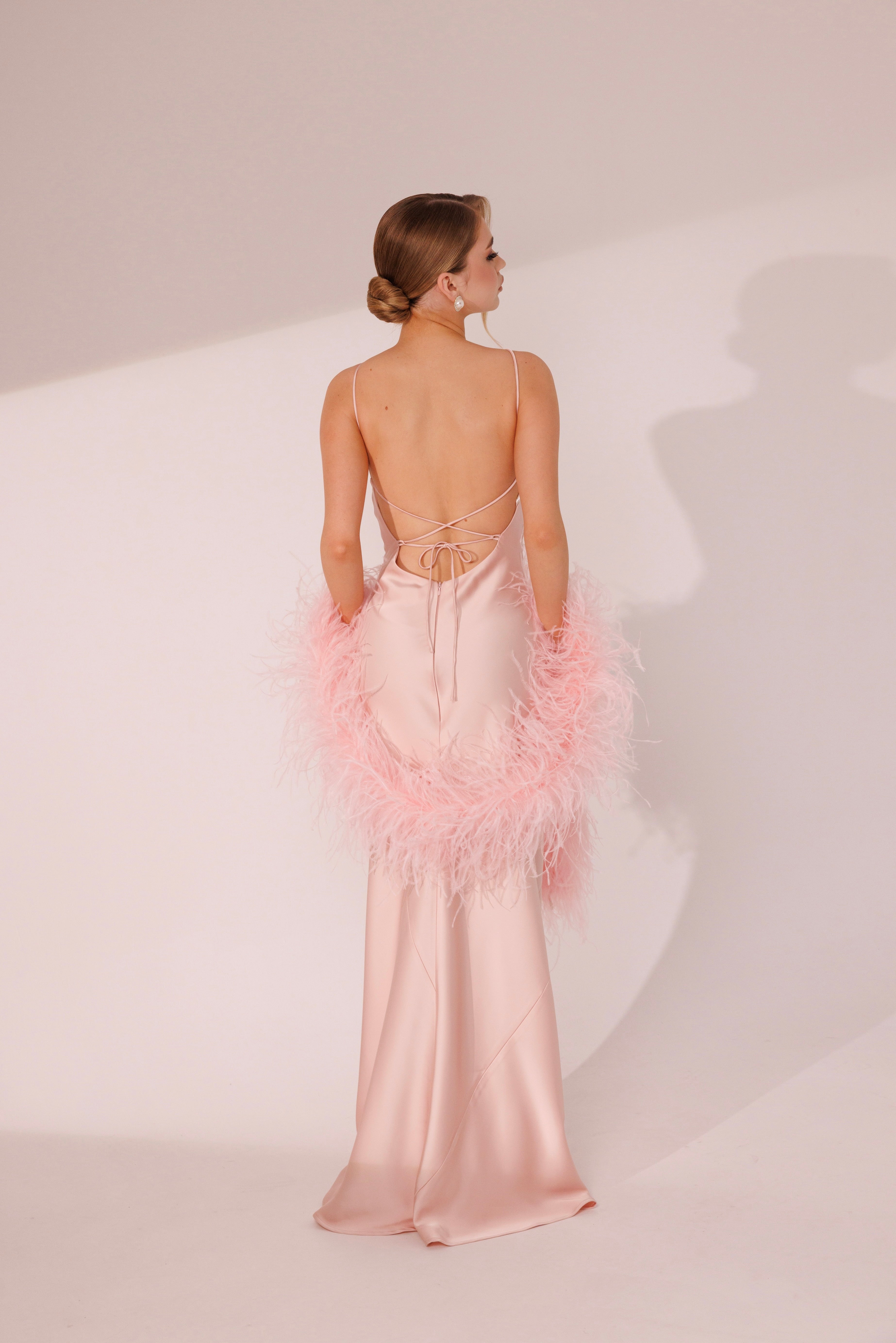 Back view of Elara Dress in pink color with lace-up open back