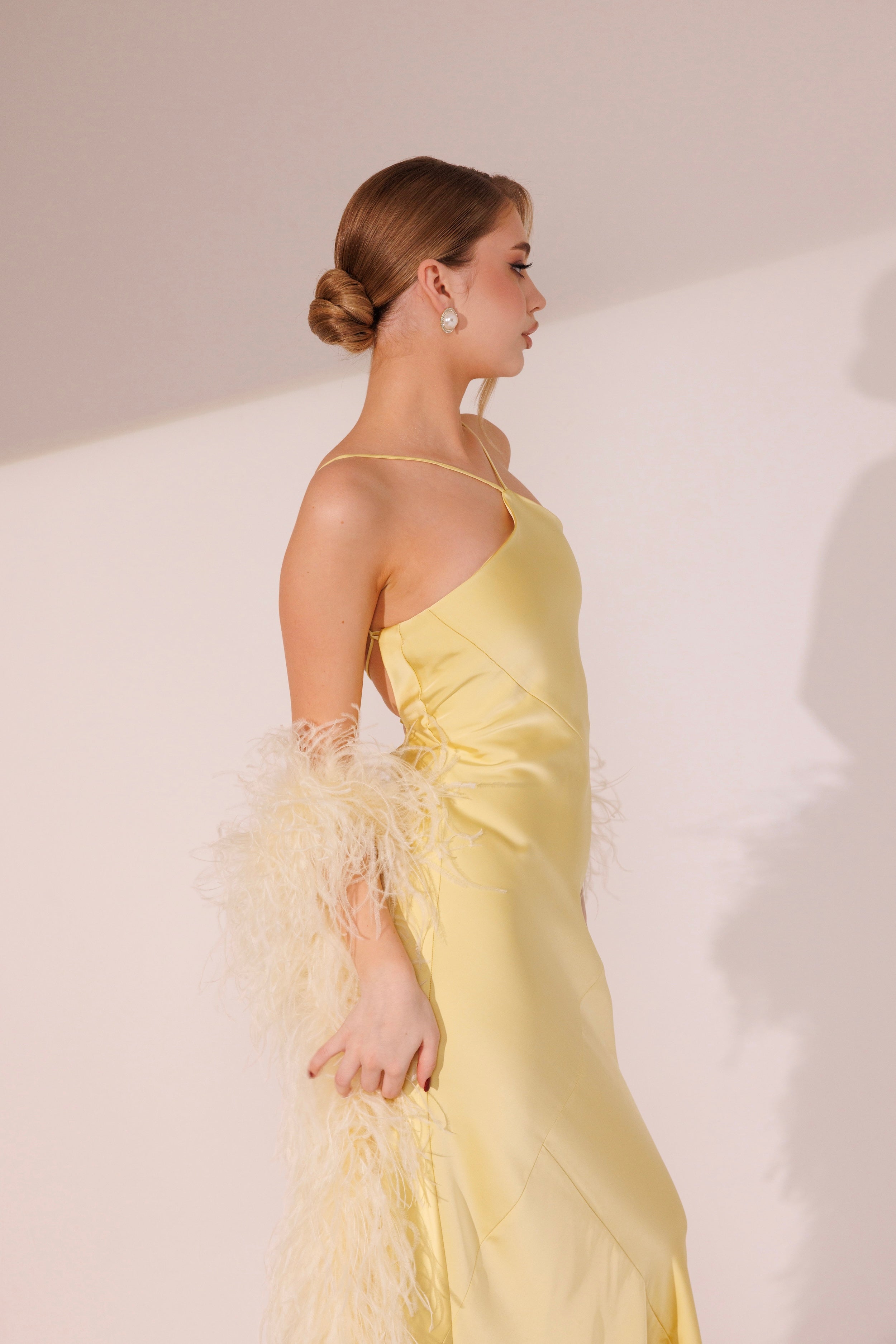 Side view of Elara Dress in yellow color with fitted silhouette