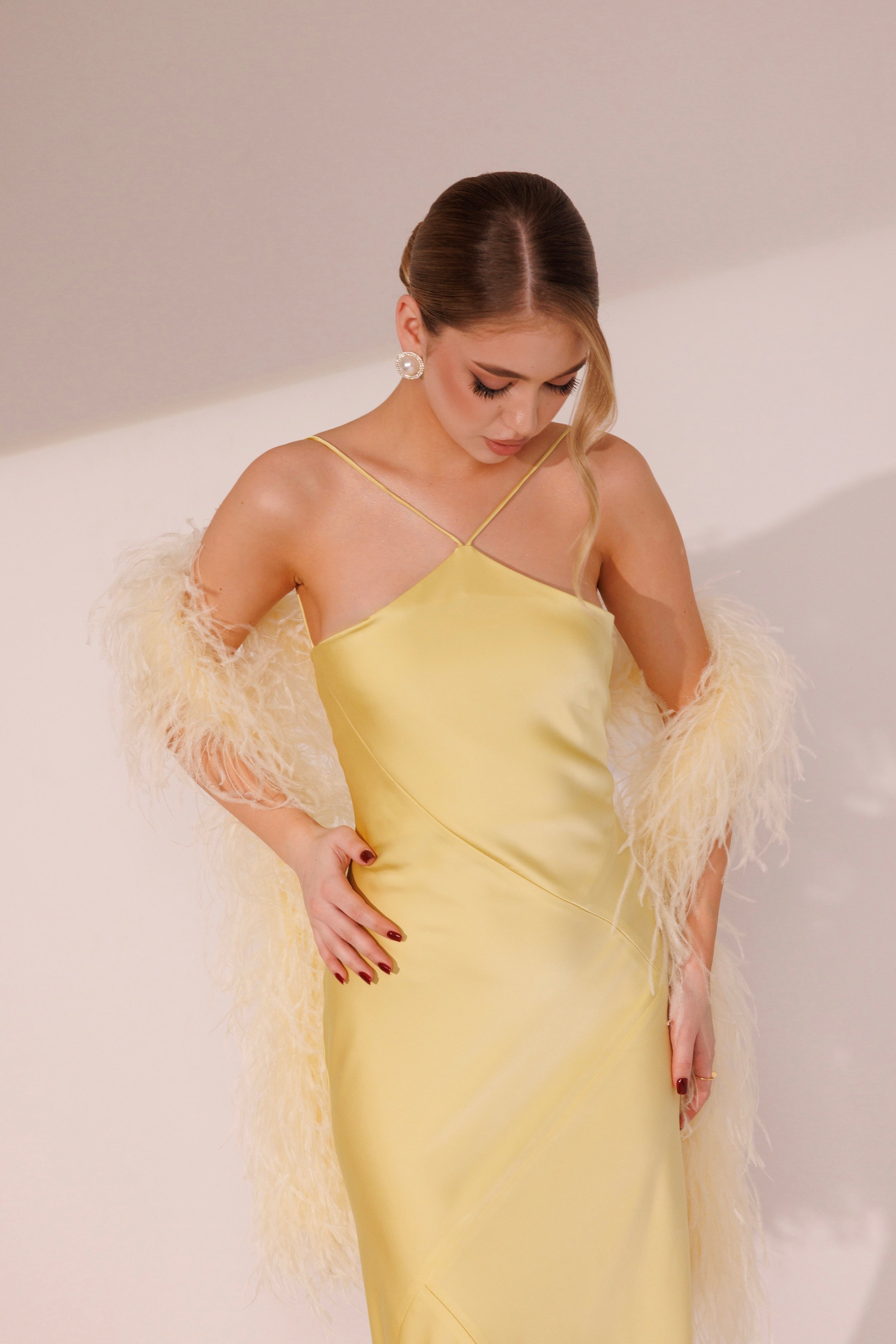 Model wearing Elara Dress in yellow color for evening occasions
