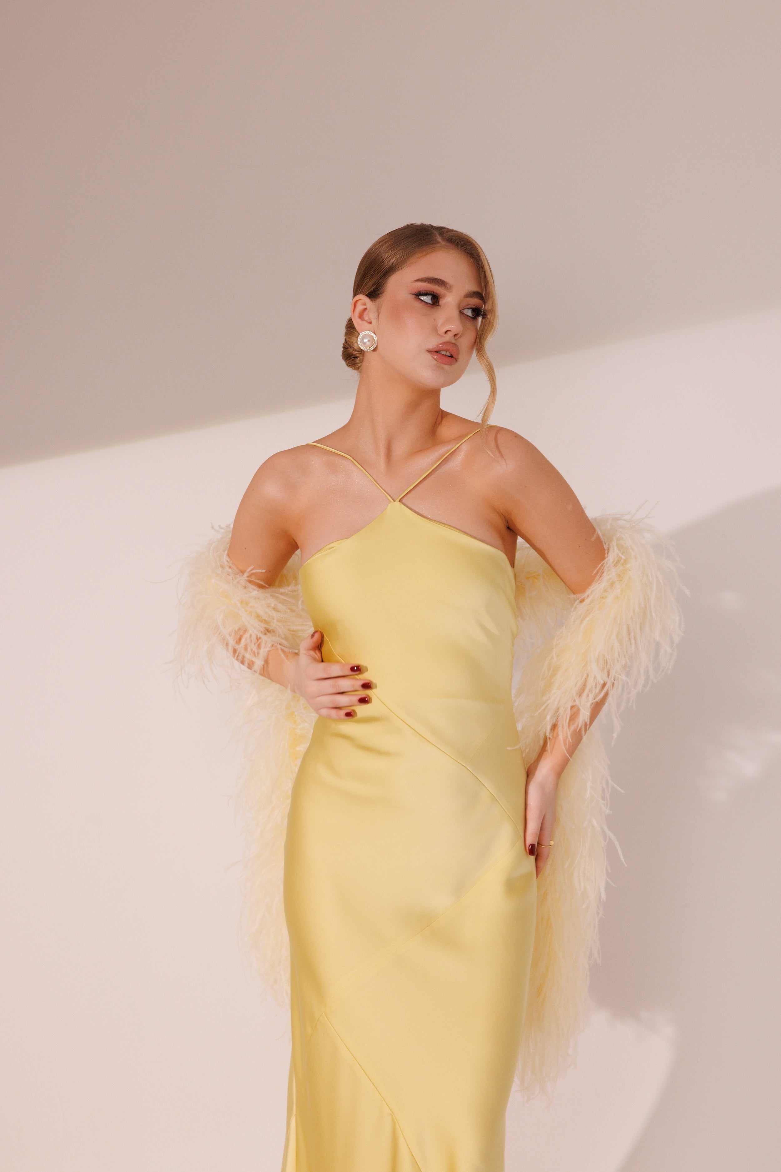 Elara Dress in yellow color styled with matching feather boa