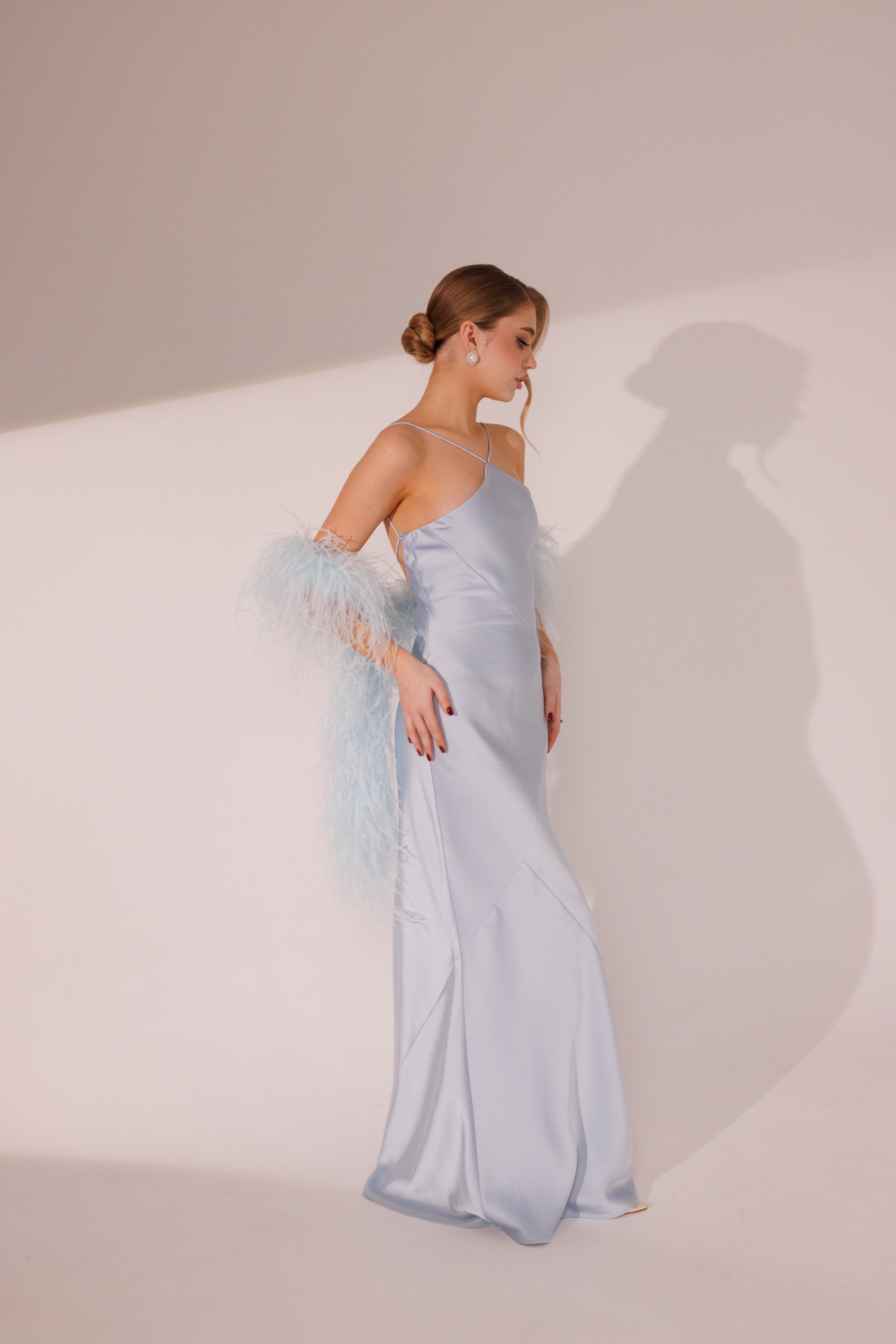 Side view of Elara Dress in blue color with fitted silhouette