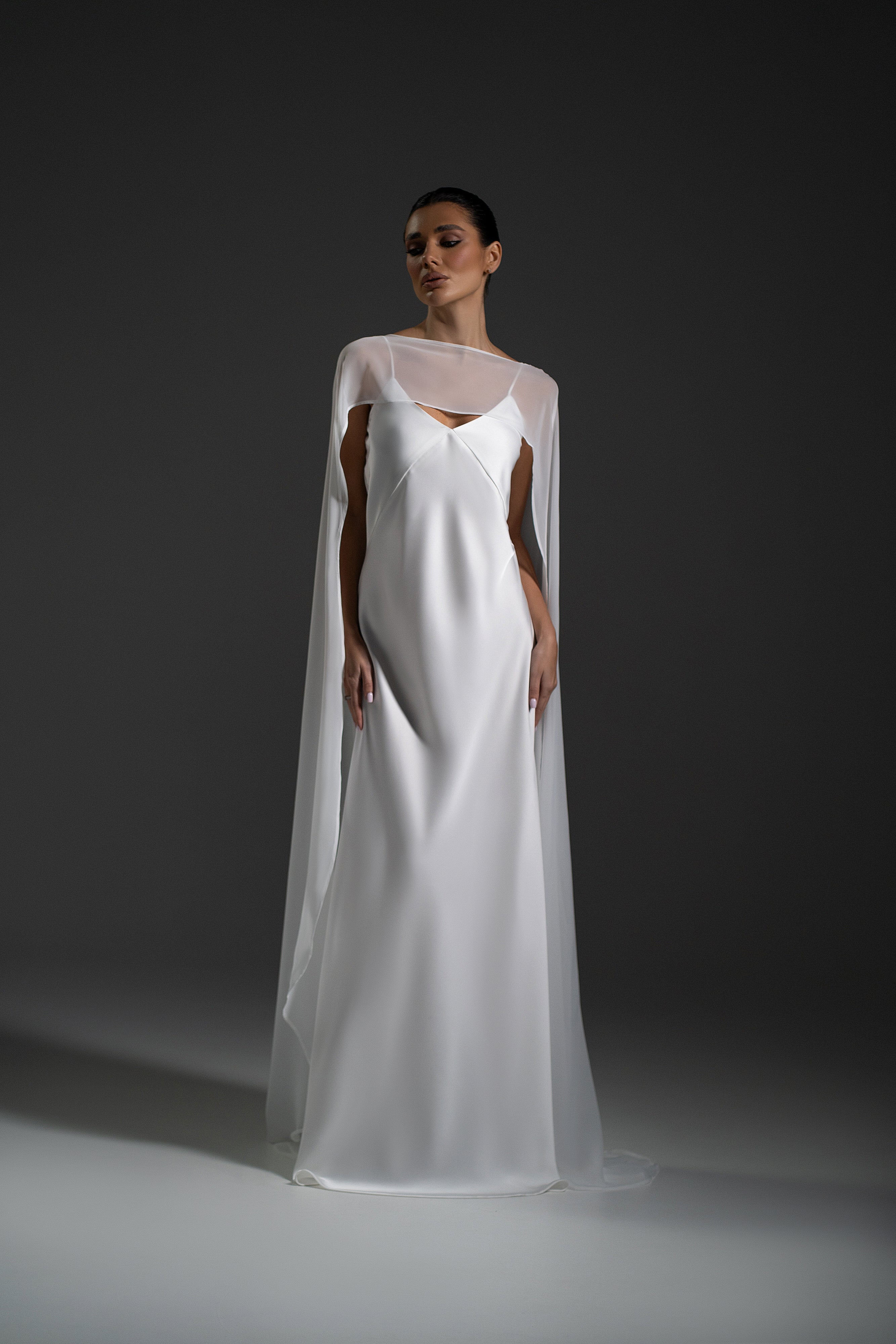 Luna Dress in white color with flowing cape sleeves and elegant maxi silhouette by Lafatale Atelier