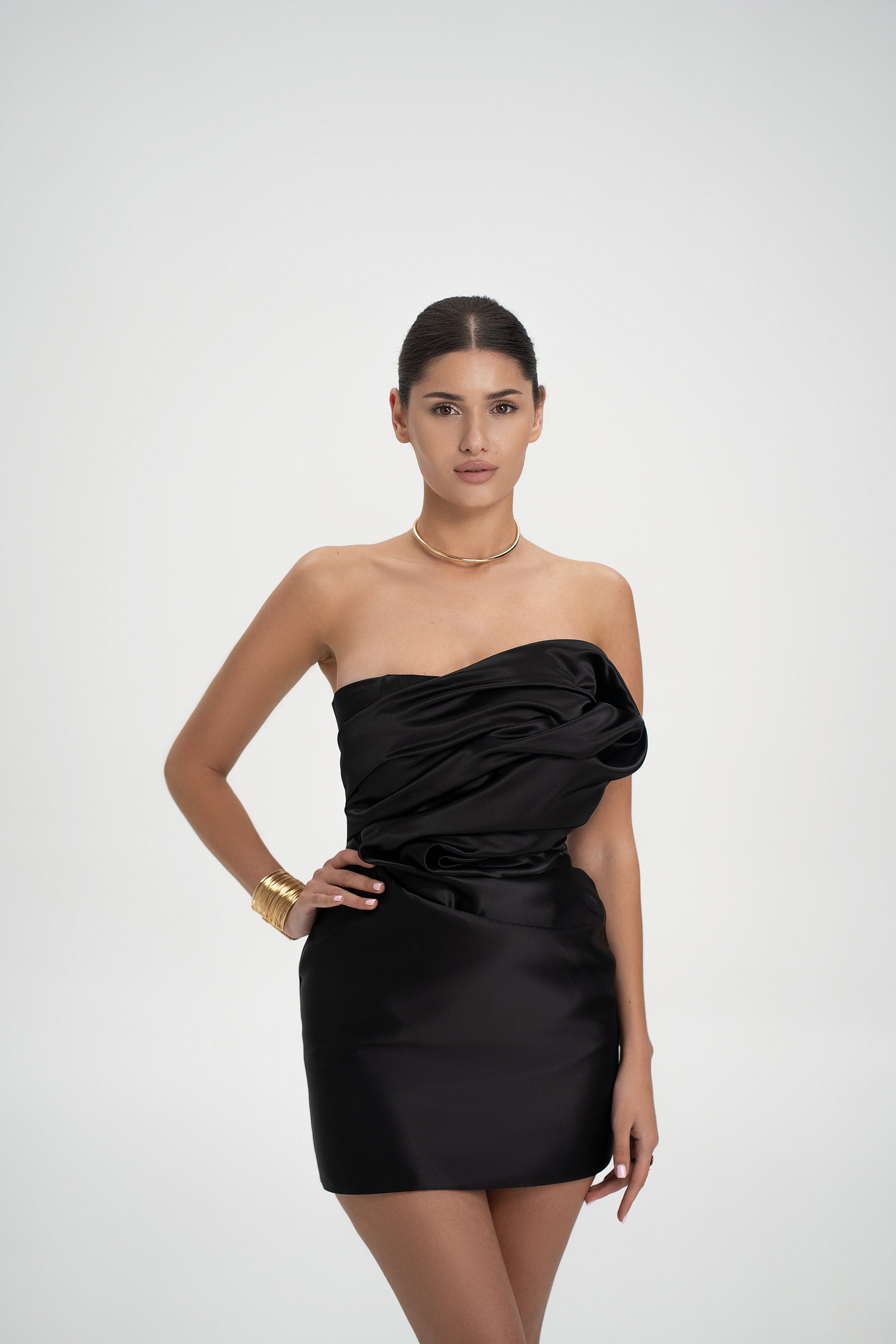 Front view of Serene Dress in black color with sculpted satin mini silhouette